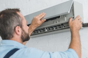 male-worker-fixing-air-conditioner-at-home.jpg